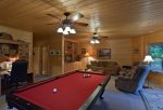 Terrace level pool table and desk area with a flat screen TV